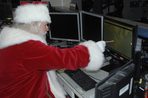 Santa Claus reviews his flight plan for his Dec. 25 trek across the globe in the North American Aerospace Defense Command and U.S. Northern Command Current Operations Center Thursday, Sept. 26, 2013, at the NORAD and USNORTHCOM headquarters at Peterson Air Force, Colo. Santa’s visit today comes in advance of the commands' annual NORAD Tracks Santa outreach effort, which is expected to reach more than 20 million unique visitors on the www.noradsanta.org website.